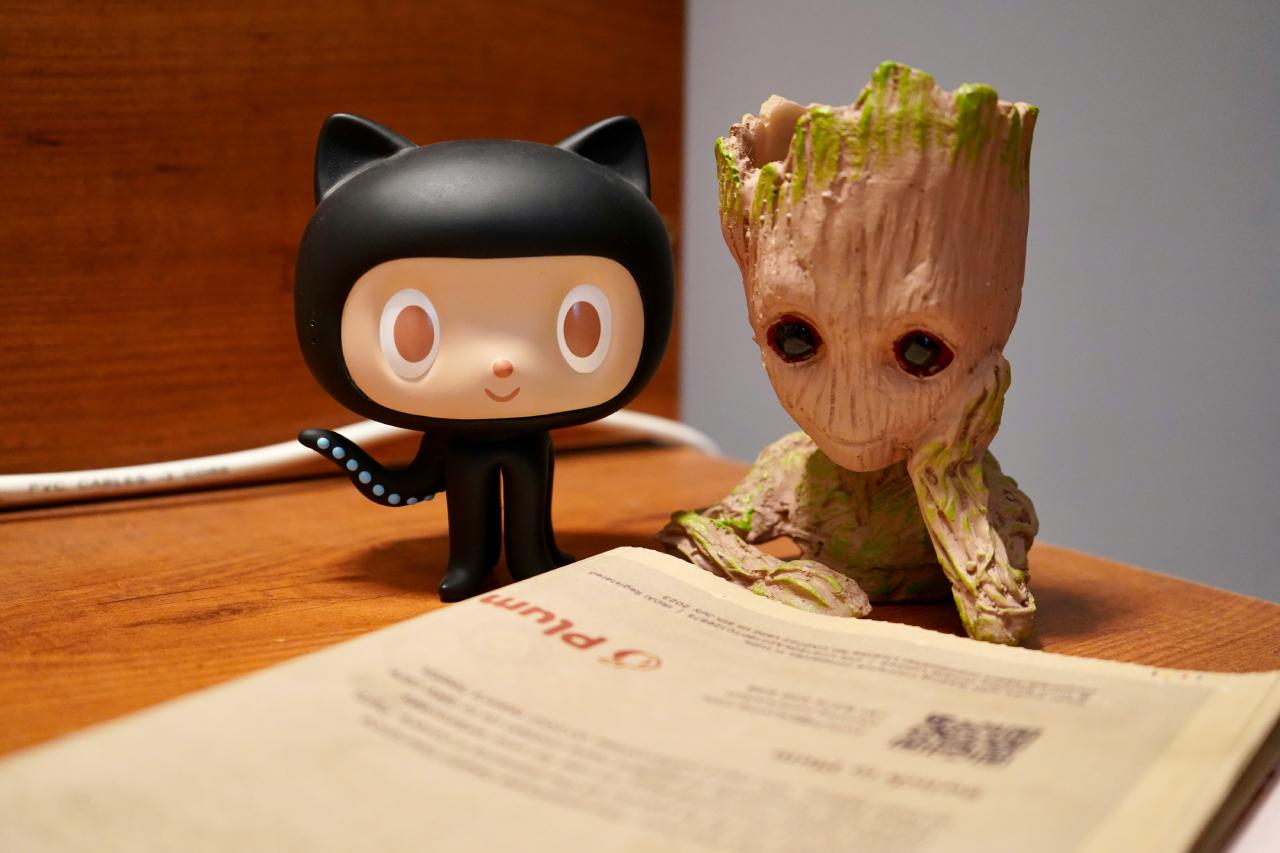 Photo of two cute figurines reading a newspaper
